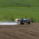 Farmer riding a tractor