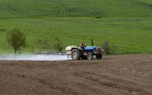 Farmer on tractor spraying