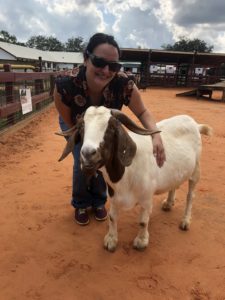 Lisa Gonzalez standing next to goat.