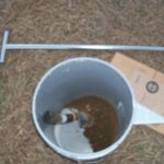 Bucket with soil and soil testing probe