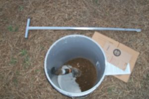 Bucket with soil and soil testing probe