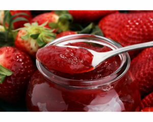 Strawberries with jam on spoon