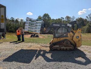 Skyler operating a skid steer