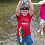 boy fishing with trout